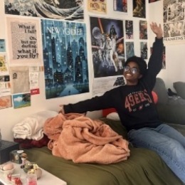 person posing in front of posters